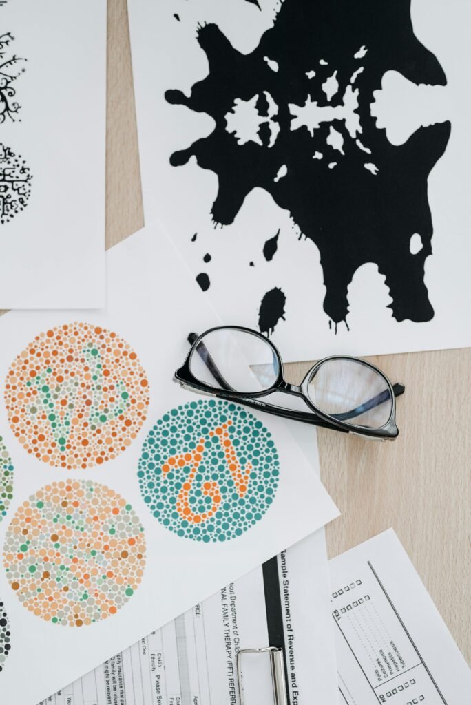 pexelsphoto82049888204988 Crystal Clear Eye Clinic Best Eye Clinic in Andheri Mumbai Flat lay of color blindness tests and inkblot cards with eyeglasses for vision assessment