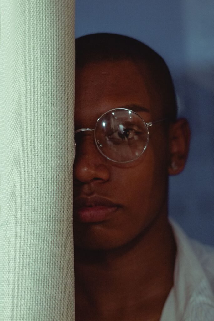 Close up portrait of a man with eyeglasses showcasing modern fashion and serious expression